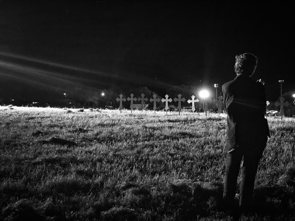 <p>A woman stands near 26 crosses set up in honor of those killed in Sunday’s mass shooting in Sutherland Springs, Texas. (Photo: Holly Bailey/Yahoo News) </p>