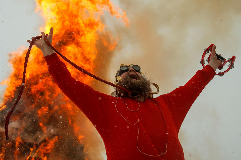 <p>Artist German Vinogradov acts in the performance of the burning of Maslenitsa tower, devoted to Pancake Week, a pagan holiday marking the end of winter, in the village of Nikola-Lenivets, Kaluga region, Russia, February 25, 2017. (Maxim Shemetov/Reuters) </p>