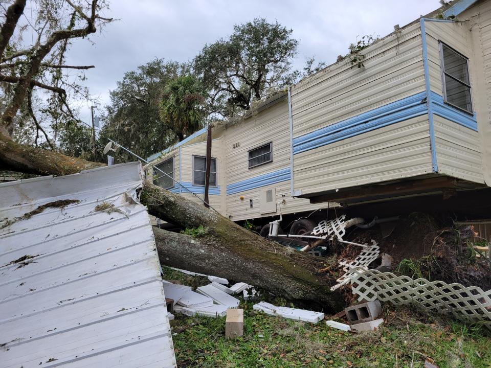 A trailer dislodged by a fallen tree sat several feet off its base Thursday afternoon at Hammock Lake Estates mobile home park in Fort Meade.