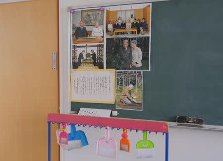 Pictures of the Japanese imperial family are displayed on a blackboard in a classroom at Tsukamoto kindergarten in Osaka, Japan, November 30, 2016. REUTERS/Ha Kwiyeon/Files