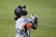 San Francisco Giants' Brandon Crawford gestures skyward as he approaches the plate after hitting a three-run home run off Texas Rangers reliever Taylor Hearn during the ninth inning of a baseball game in Arlington, Texas, Tuesday, June 8, 2021. (AP Photo/Tony Gutierrez)