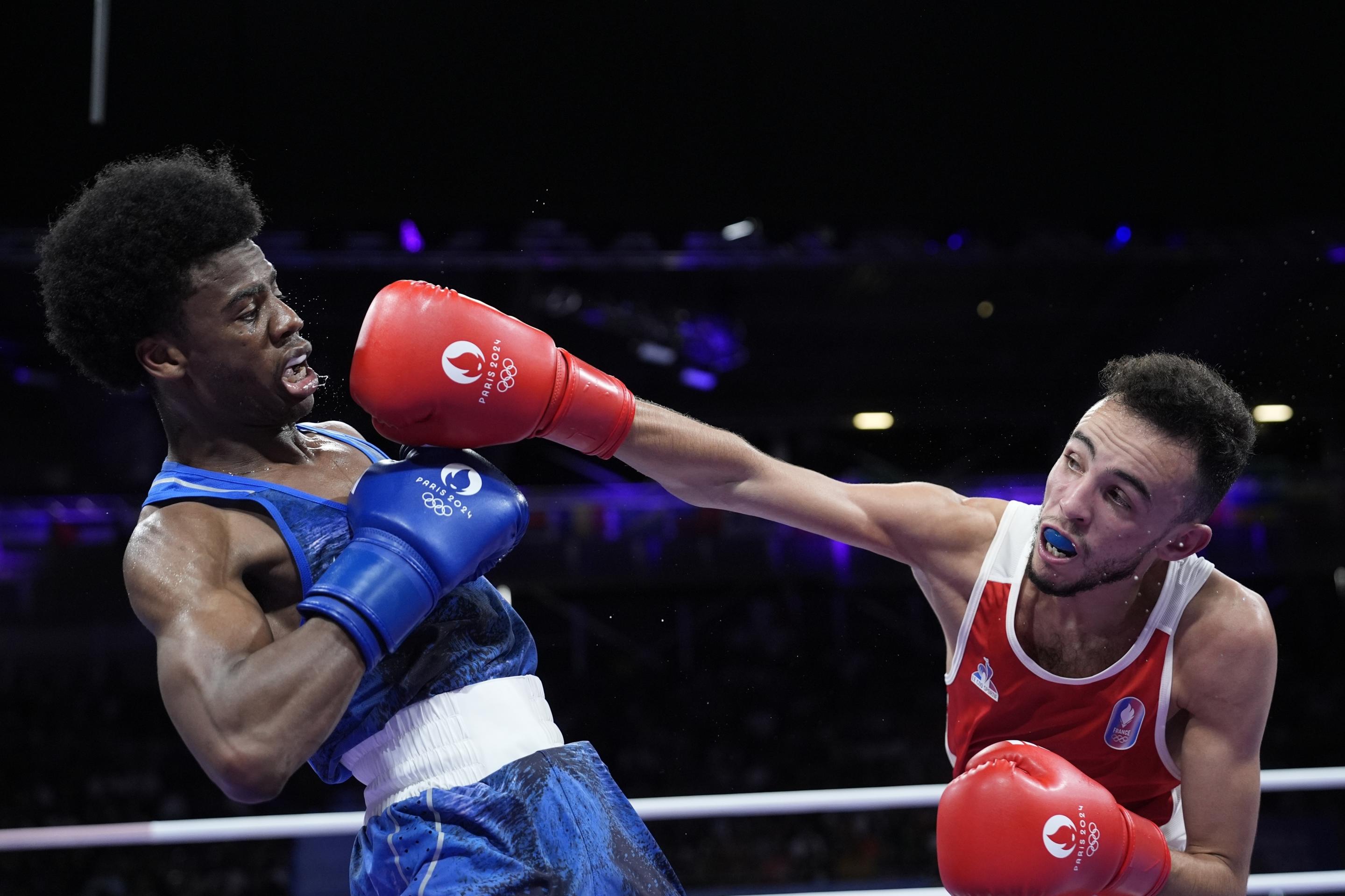 France's Billal Bennama, right, fights United States' Roscoe Hill in their men's 51kg preliminary boxing match at the 2024 Summer Olympics on July 30, 2024, in Paris, France. (John Locher/AP)