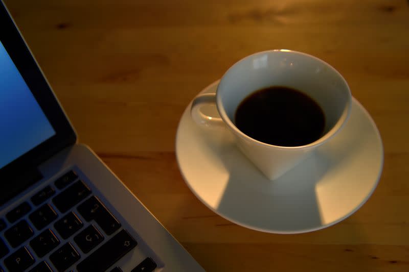 FILE PHOTO: An illustration picture shows a coffee cup near a laptop