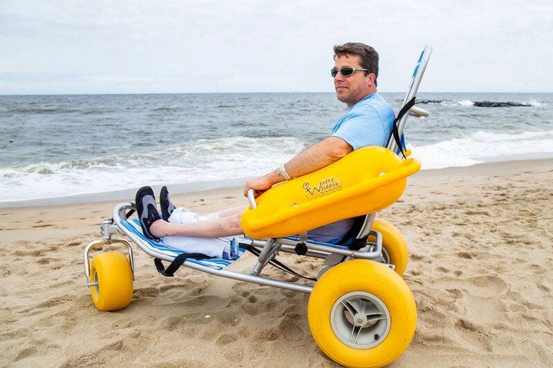 Surf wheelchair users sit in a recumbent position between pontoons that serve as both armrests and floatation devices.