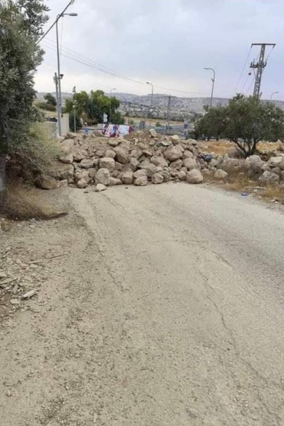 Rubble and concrete boulders block a road in Bayt Ta’mar, a village near Bethlehem (Saed)