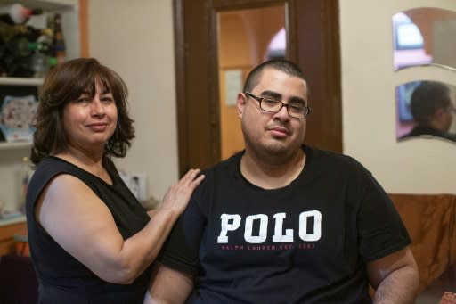 Gregory Rodriguez and his mother, Martha, pose at their home in New York on November 22, 2019