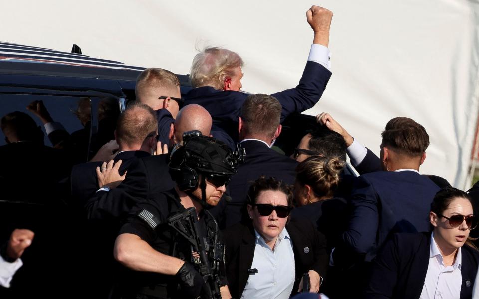 Trump remains defiant as he is taken to hospital