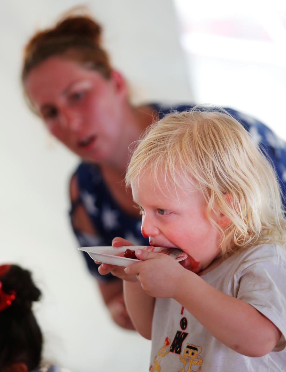 Mehgan Craft watches her 2-year-old son Nickolaz Garza win the Cherry Cobbler eating contest. Kids and adults participated in the River Smith’s Catfish and Cobbler Eating contest on Monday, July 4, 2022. (Mark Rogers/For A-J Media)