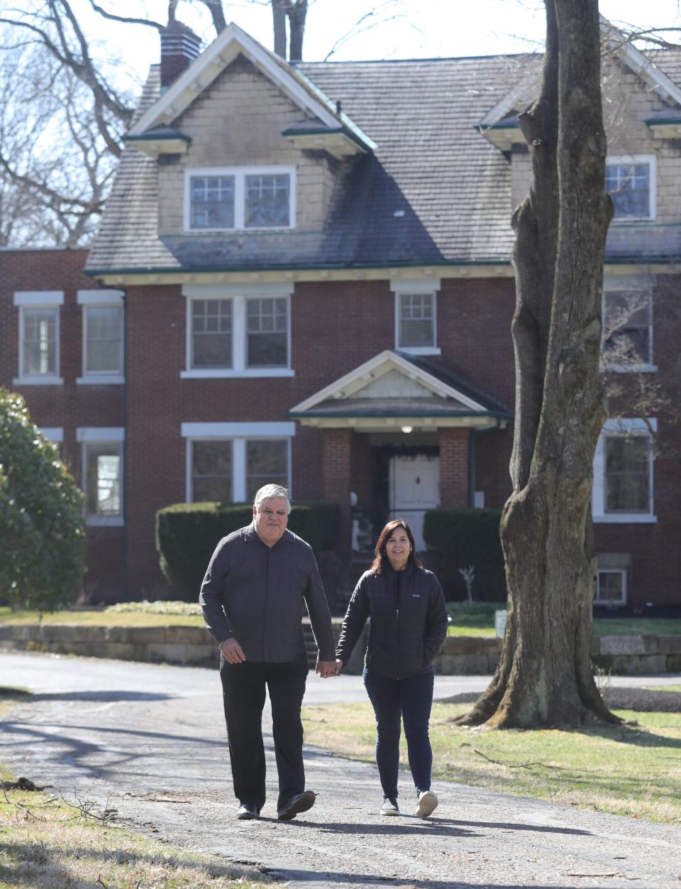 Prime Vine Winery owners Jim and Julie Pulk stand March 30 outside their newly remodeled mansion on Manchester Road in New Franklin.