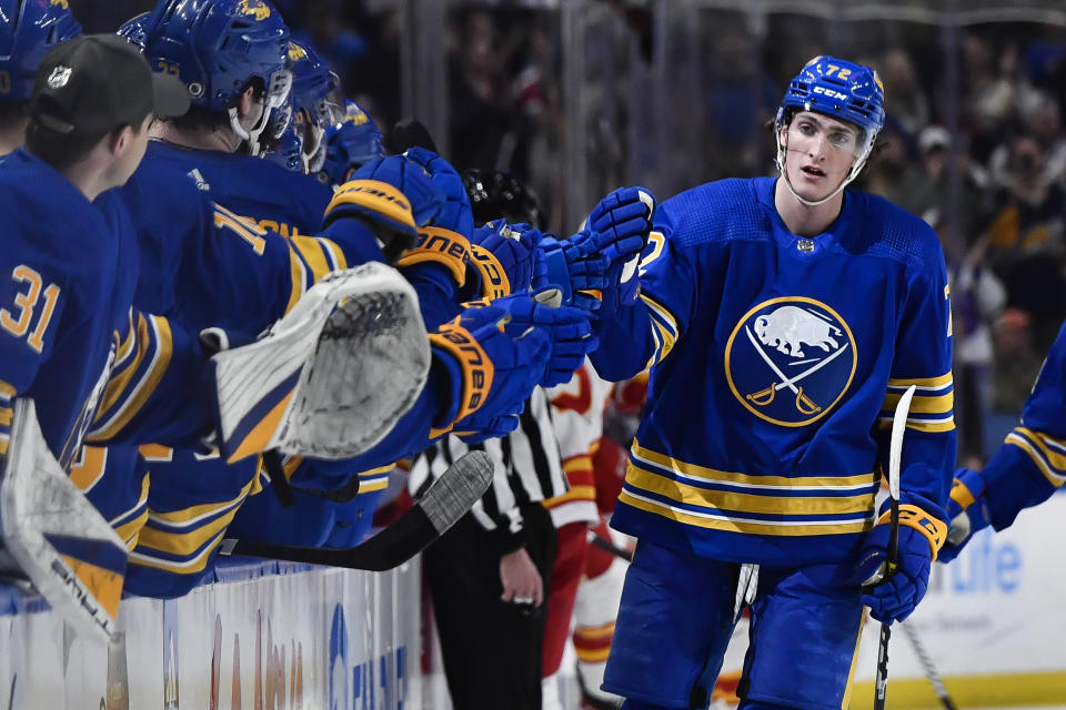 Buffalo Sabres center Tage Thompson, right, celebrates after scoring against the Calgary Flames during the first period of an NHL hockey game in Buffalo, N.Y., Saturday, Feb. 11, 2023. (AP Photo/Adrian Kraus)