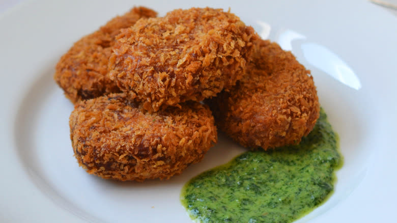 Masala lentil and sweet potato croquettes on white plate