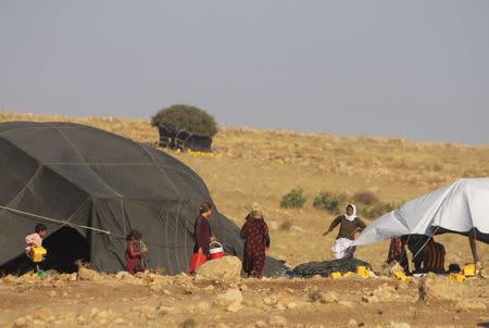 Displaced people from the Yazidi religious minority, who fled the violence from forces loyal to the Islamic State in Sinjar town, take shelter in Mount Sinjar August 13, 2014. REUTERS/Rodi Said