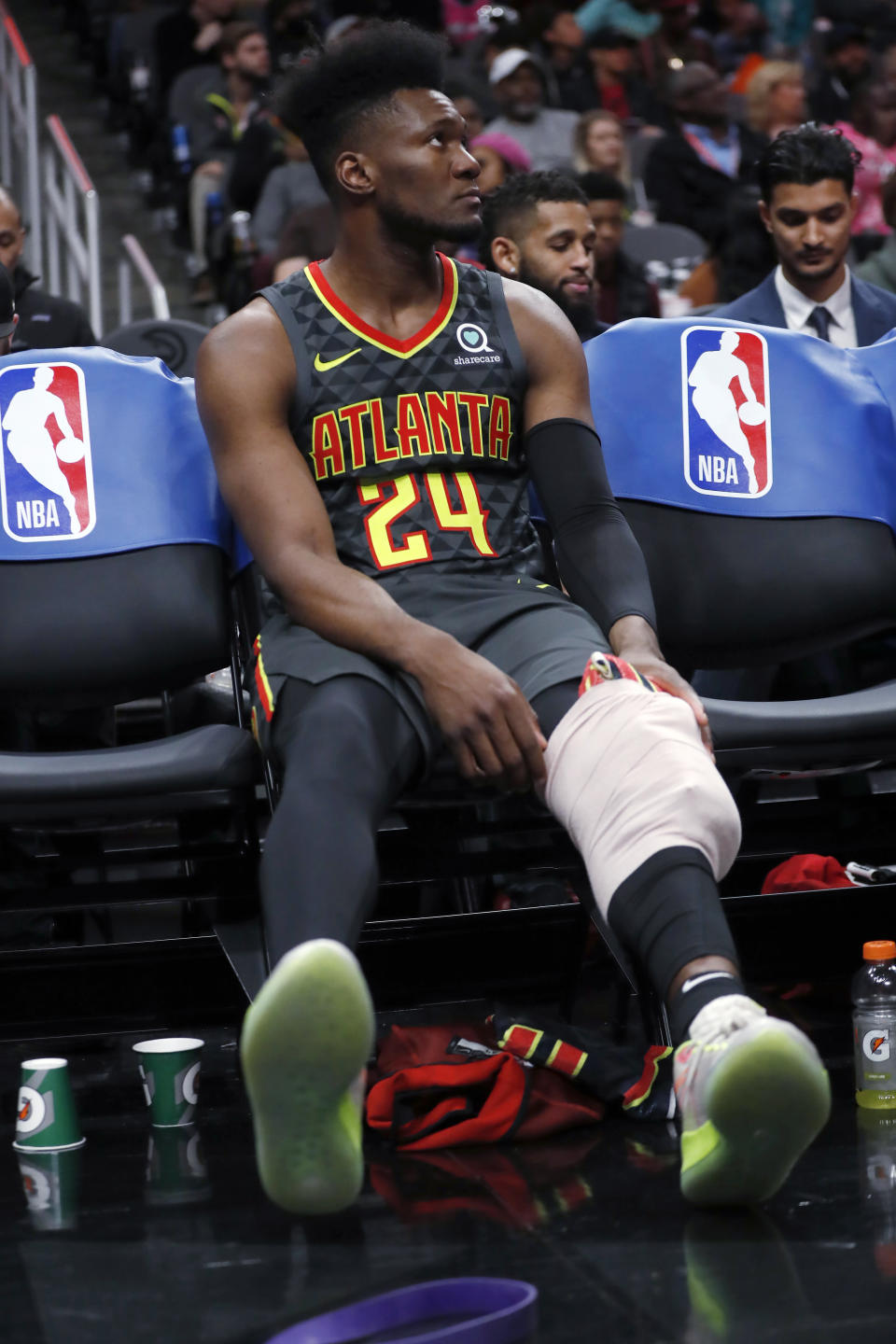 Atlanta Hawks forward Bruno Fernando (24) ices his knee during the first half of the team's NBA basketball game against the Miami Heat on Thursday, Oct. 31, 2019, in Atlanta. (AP Photo/John Bazemore)