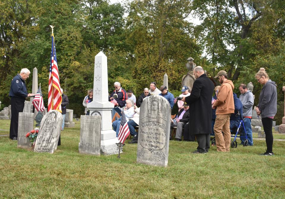 At least 20 people gathered Saturday morning at Weston Village Cemetery and listened to words of the Rev. Larry Betz, minister at the First Church of Nazarene in Adrian, left, who spoke about sacrifices made by all veterans of the United States armed forces, including Revolutionary War veterans.
