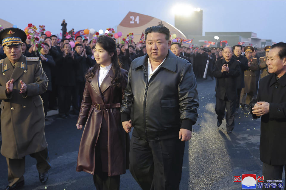 In this photo provided by the North Korean government, North Korean leader Kim Jong Un, center right, and his daughter attend a completion and operation ceremony of Kangdong Greenhouse Farm in Pyongyang, North Korea Friday, March 15, 2024. Independent journalists were not given access to cover the event depicted in this image distributed by the North Korean government. The content of this image is as provided and cannot be independently verified. Korean language watermark on image as provided by source reads: "KCNA" which is the abbreviation for Korean Central News Agency. (Korean Central News Agency/Korea News Service via AP)