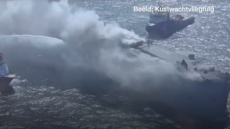 An aerial view of the Fremantle Highway, a 635-foot long cargo ship engulfed in white smoke.
