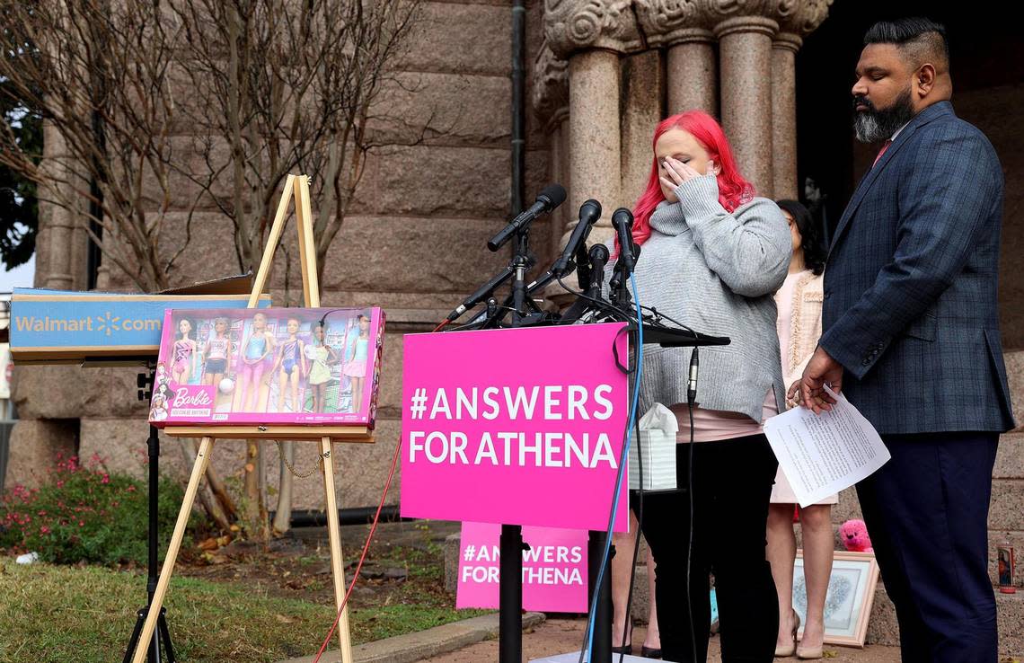 Maitlyn Gandy, mother of Athena Strand, wipes a tear while giving a press conference with attorney Benson Varghese, right, on Thursday, Dec. 8, 2022, at the Wise County Courthouse in Decatur. Gandy presented the box that was delivered by the FedEx driver accused of killing her daughter on the day Athena Strand, 7, was abducted. Inside was a Christmas present for Athena.