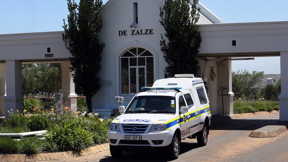 A police vehicle exits the upmarket De Zalze housing estate in Stellenbosch, South Africa, where three members of the van Breda family were killed. Source: AAP