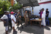 Army soldiers register people who are waiting to buy fuel at a fuel station in Colombo, Sri Lanka, Monday, June 27, 2022. Sri Lanka is sending two ministers to Russia to negotiate for fuel — one of the necessities that the Indian ocean island nation has almost run out of amid its ongoing economic crisis. (AP Photo/Eranga Jayawardena)