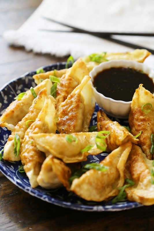 <p>The Comfort of Cooking</p><p>Crispy, tender steamed potstickers, made easily in one skillet! Dunk them in a delicious homemade dipping sauce to really bring out the chopstick-lickin-good flavor. These make a perfect meal or easy side dish for grilled meats and vegetables.</p><p><strong>Get the recipe: <a href="http://www.thecomfortofcooking.com/2018/07/easy-asian-dumplings-with-soy-ginger-dipping-sauce.html" rel="nofollow noopener" target="_blank" data-ylk="slk:Easy Asian Dumplings with Soy Ginger Dipping Sauce;elm:context_link;itc:0;sec:content-canvas" class="link rapid-noclick-resp"><em>Easy Asian Dumplings with Soy Ginger Dipping Sauce</em></a></strong></p>