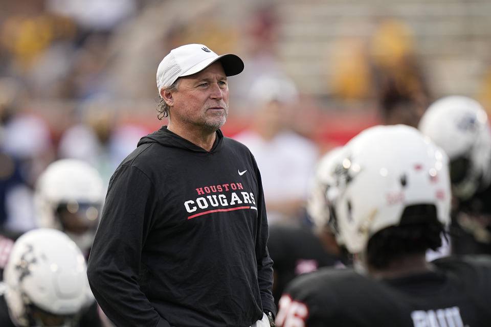 Houston coach Dana Holgorsen watches players warm up for an NCAA college football game against West Virginia, Thursday, Oct. 12, 2023, in Houston. (AP Photo/Kevin M. Cox)