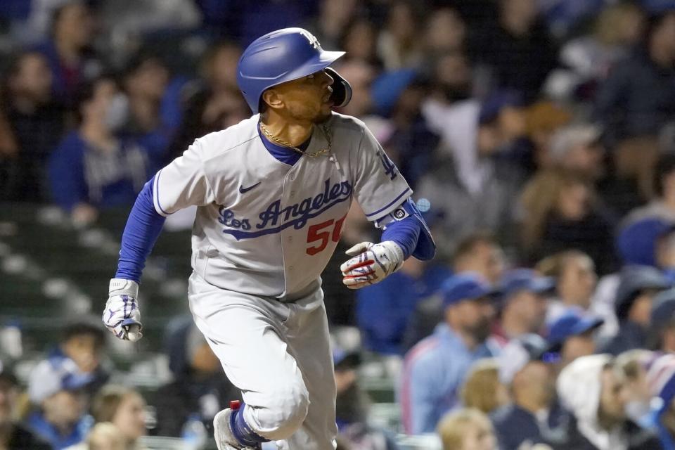 The Dodgers' Mookie Betts watches his two-run home run off Cubs relief pitcher David Robertson Saturday