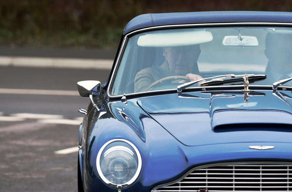 The Prince of Wales driving his Aston Martin DB6 arrives for a visit to the Aston Martin Lagonda factory at St Athan in Barry, Wales.