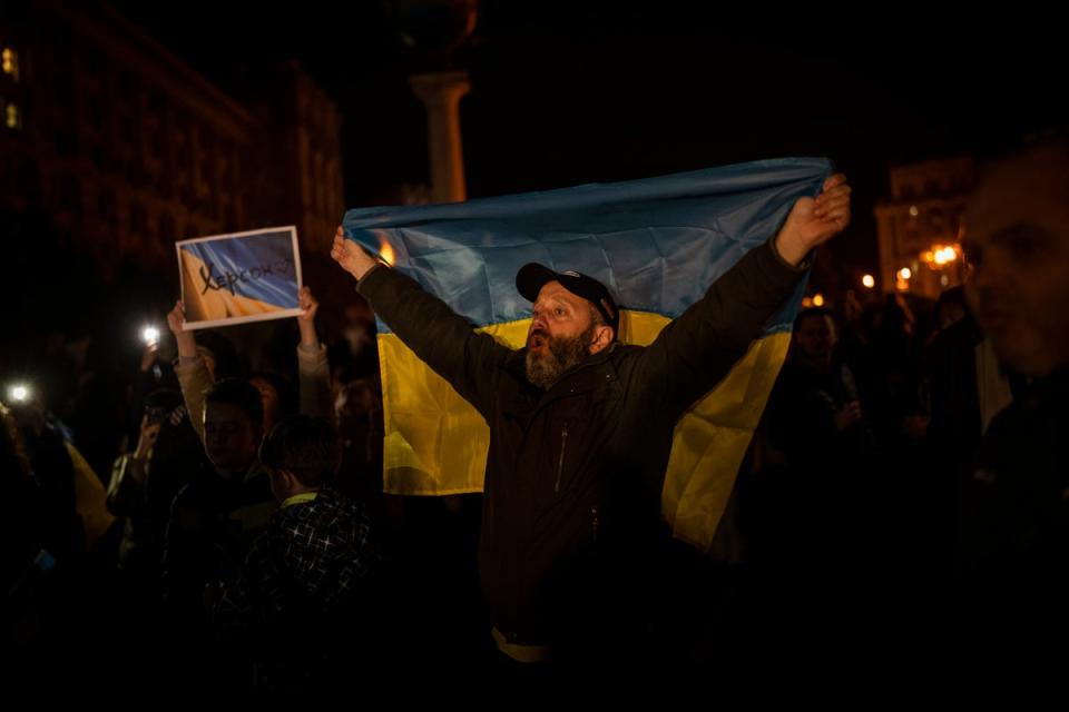 Ukrainians gather in central Kyiv to celebrate the recapturing of Kherson city (AP)