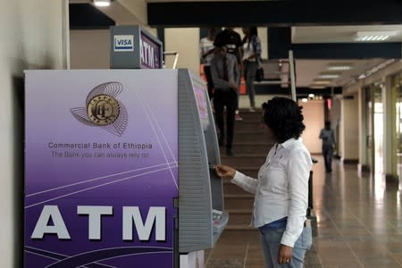 A client uses an automated teller machine (ATM) at the Commercial Bank of Ethiopia in Addis Ababa