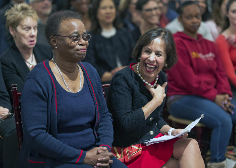 University of Southern California Interim President Wanda Austin, left, and Carol Folt smile before Folt was officially named as the University of Southern California's 12th president in Los Angeles, Wednesday, March 20, 2019. The announcement comes a week after news broke of a massive college bribery scam involving USC and other universities across the country. Folt most recently was formerly the chancellor of the University of North Carolina at Chapel Hill (UNC). She will take office as USC's new president on July 1. (AP Photo/Damian Dovarganes)