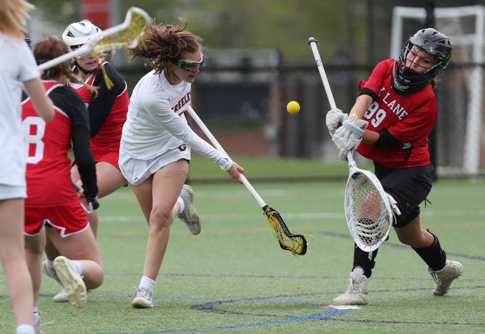 Greeley's Sydney Mikesell (8) fires a shot that was stopped by Fox Lane goalie Sophie Kothari (99) during girls lacrosse action at Horace Greeley High School in Chappaqua May 4, 2022. Greeley won the game 13-9. 