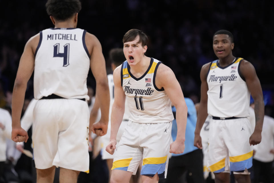 Marquette's Tyler Kolek (11) reacts after Stevie Mitchell (4) scores three points in the first half of an NCAA college basketball game against Xavier for the championship of the Big East men's tournament, Saturday, March 11, 2023, in New York. (AP Photo/John Minchillo)