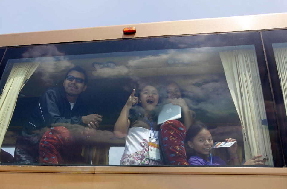 In this photo taken Friday, June 8, 2012, visitors riding in a bus react to the sight of nine "sub-adults" African elephants, ranging from 4 to 10 years old, roaming in their new habitat of the Africam Safari wildlife preserve, near Puebla, Mexico. The nine elephants from Namibia needed a new home and the owner of a 900-acre wildlife preserve in central Mexico jumped at the chance to buy them and add them to his a menagerie that includes ostriches, lemurs, giraffes, zebras and monkeys. (AP Photo/Andres Leighton)