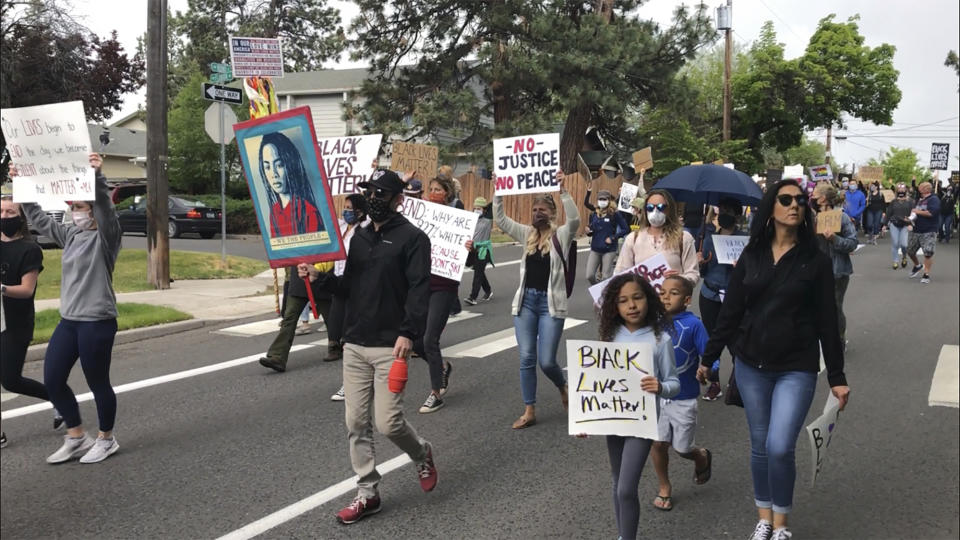 Demonstrators march Saturday, June 6, 2020, in Bend, Ore., to protest racism and police brutality. (AP Photo/Andrew Selsky)