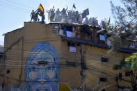 Inmates protest on the roof of a San Sebastian prison, asking for better medical attention amid the pandemic and to be given the results from previously administered COVID-19 tests, in Cochabamba, Bolivia, Monday, July 27, 2020. (AP Photo/Dico Solis)