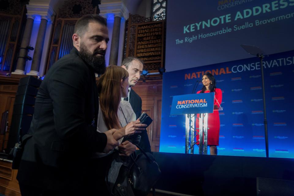 A protestor is removed from the audience during Home Secretary Suella Braverman's speech during the National Conservatism Conference at the Emmanuel Centre, central London. Picture date: Monday May 15, 2023.