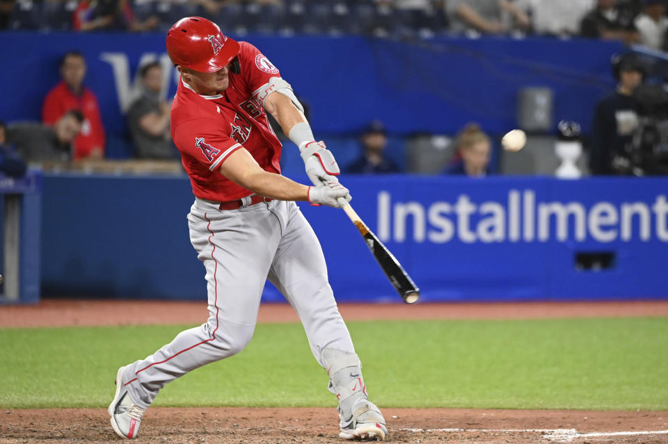 Los Angeles Angels' Mike Trout hits a two-run home run, also scoring David Fletcher, off Toronto Blue Jays relief pitcher Yusei Kikuchi during seventh-inning baseball game action in Toronto, Friday, Aug. 26, 2022. (Jon Blacker/The Canadian Press via AP)