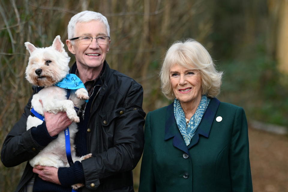 Britain's Camilla, Duchess of Cornwall, patron of Battersea Dogs and Cats Home, and Battersea Ambassador Paul O'Grady walk with a rescue dog during her visit to Battersea Brands Hatch Centre in Ash, Kent, Britain February 2, 2022. Stuart C. Wilson/Pool via REUTERS
