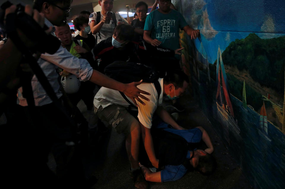 A pro-government supporter passes out after he was beaten up by anti-extradition supporters outside the office of pro-China lawmaker Junius Ho in Tsuen Wan in Hong Kong, China July 22, 2019. (Photo: Edgar Su/Reuters)