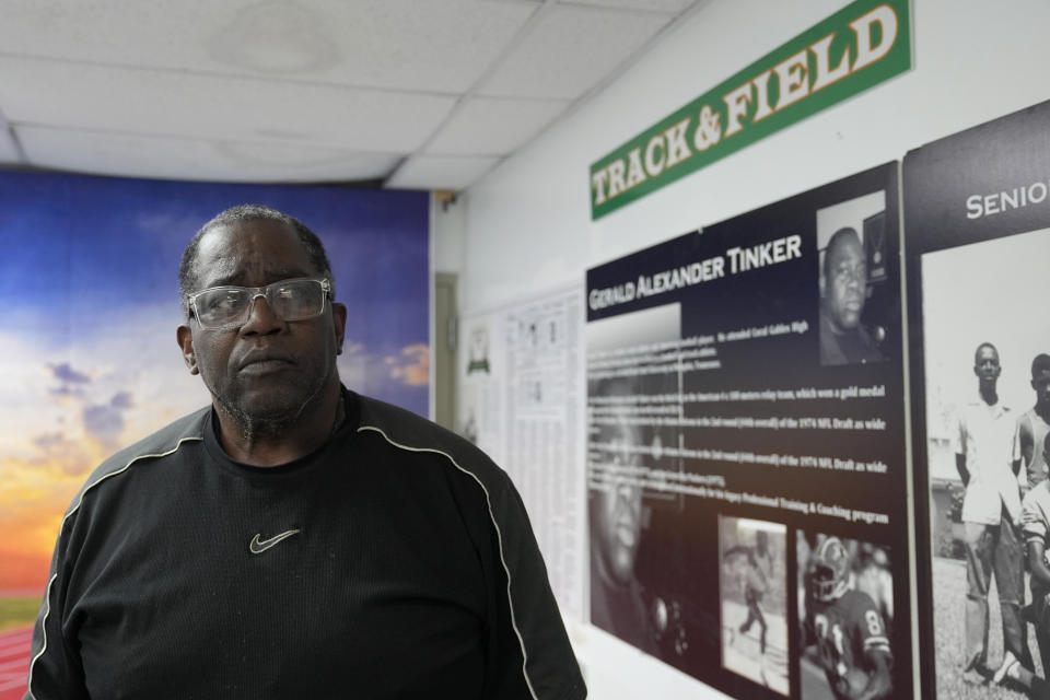 Gerald Alexander Tinker, a gold medal winner in the 1972 Olympics, and former NFL player, stands in the Coconut Grove Sports Hall of Fame in the Miami neighborhood of west Coconut Grove, Thursday, Feb. 15, 2024. The majority-Black neighborhood — known by names such as West Grove, Black Grove, or even Little Bahamas, in a nod to its Bahamian roots — has nurtured the early careers of numerous notable sports figures. Today, few remnants of that proud Black heritage exist. Years of economic neglect followed by recent gentrification have wiped out much of the neighborhood’s cultural backbone. (AP Photo/Lynne Sladky)