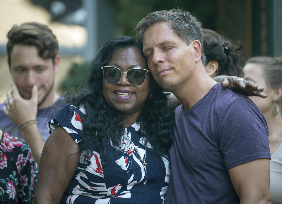 Don Damond is comforted outside his home by Valerie Castile (Aaron Lavinsky /Star Tribune via AP)