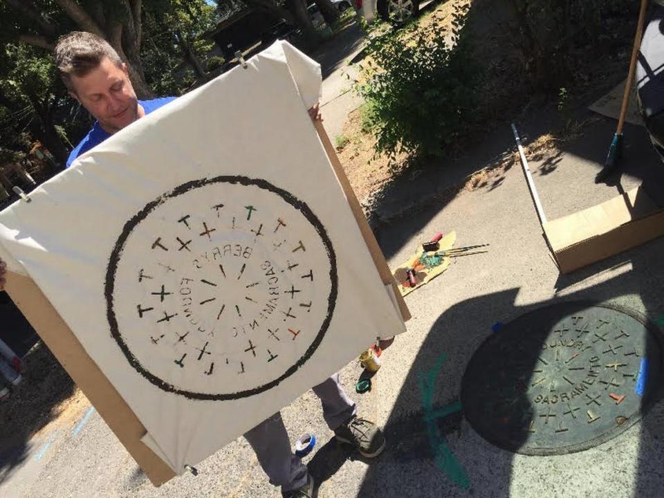 Artist Russ Muits displays a print of a Berry’s Foundry manhole cover in Sacramento in 2016.