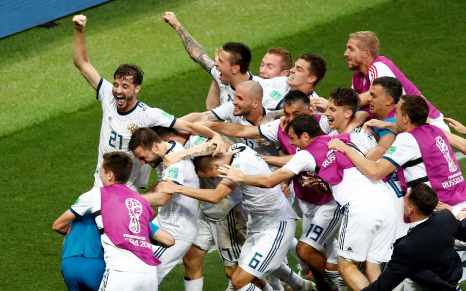 <p>Russia players mob Igor Akinfeev after he saved the penalty that sent them through to the World Cup quarter finals </p>