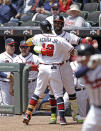 Atlanta Braves' Marcell Ozuna congratulates Ronald Acuna Jr. (13) after Acuna hit a home run off Toronto Blue Jays' Ross Stripling in the first inning of a baseball game Thursday, May 13, 2021, in Atlanta. (AP Photo/Ben Margot)