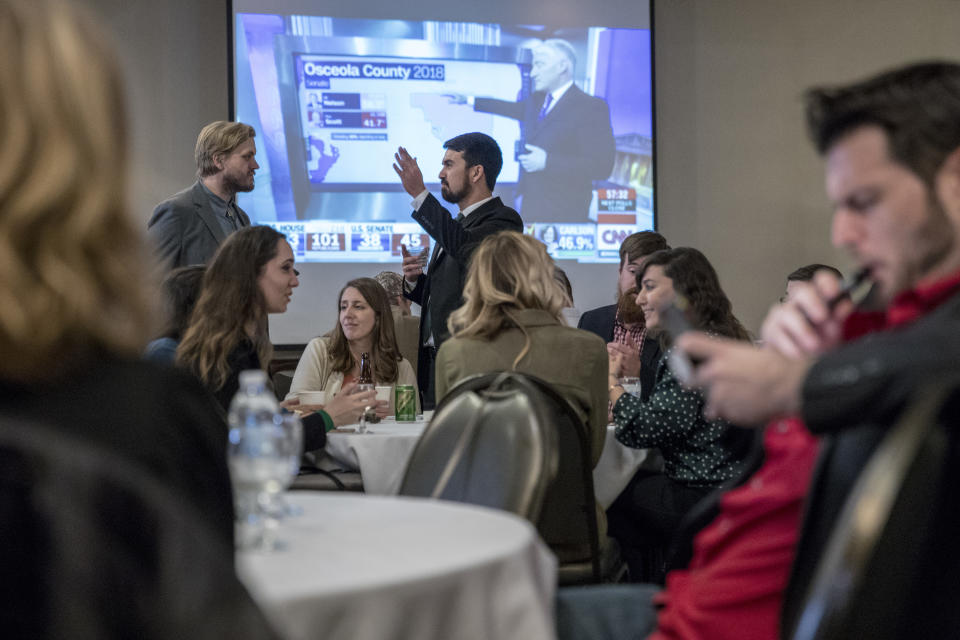 A crowd waits for election results to come in for Proposal 18-1 during the Coalition to Regulate Marijuana Like Alcohol public watch party at The Radisson in Lansing, Mich., on Tuesday, Nov. 6, 2018. (Cory Morse/The Grand Rapids Press via AP)