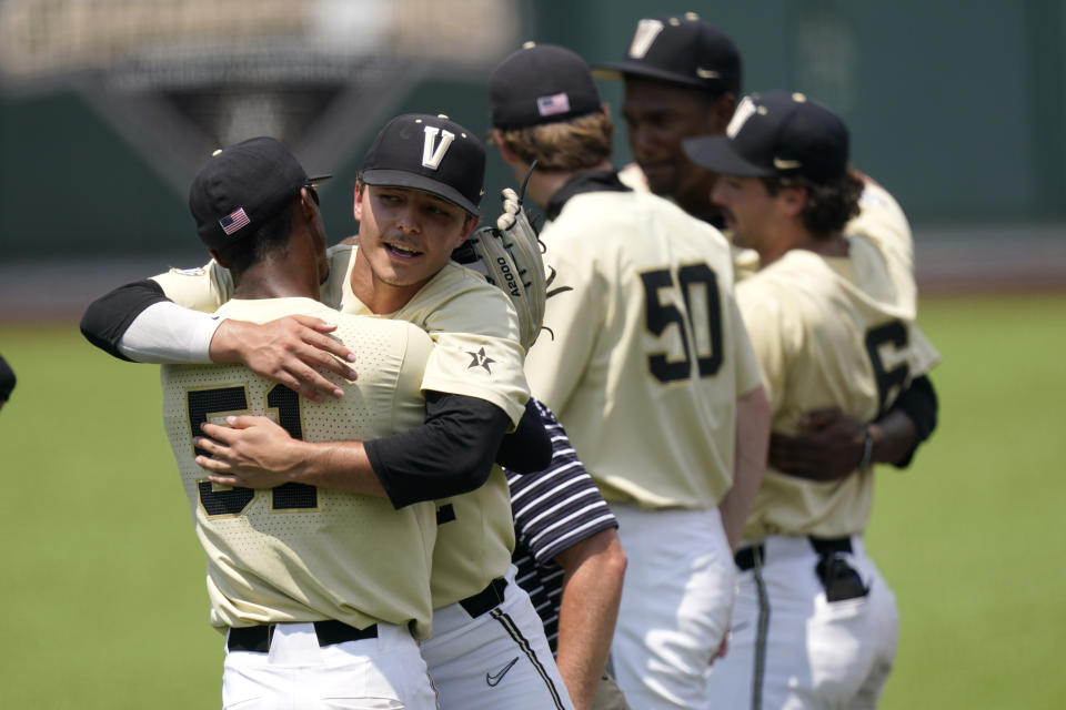 Vanderbilt's Enrique Bradfield Jr. (51) hugs winning pitcher Jack Leiter after Vanderbilt beat East Carolina in an NCAA college baseball super regional game Saturday, June 12, 2021, in Nashville, Tenn. Vanderbilt won 4-1 to sweep the three-game series and advance to the College World Series. (AP Photo/Mark Humphrey)