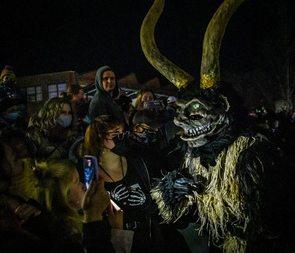 A Krampus looks for a naughty person during the 2021 Krampus parade. After two years hiatus, Krampus is returning to Bloomington for a block party Saturday.