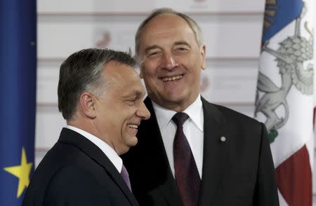 Latvian President Andris Berzins welcomes Hungarian Prime Minister Viktor Orban (L) at the Eastern Partnership Summit in Riga, Latvia, May 21, 2015. REUTERS/Ints Kalnins