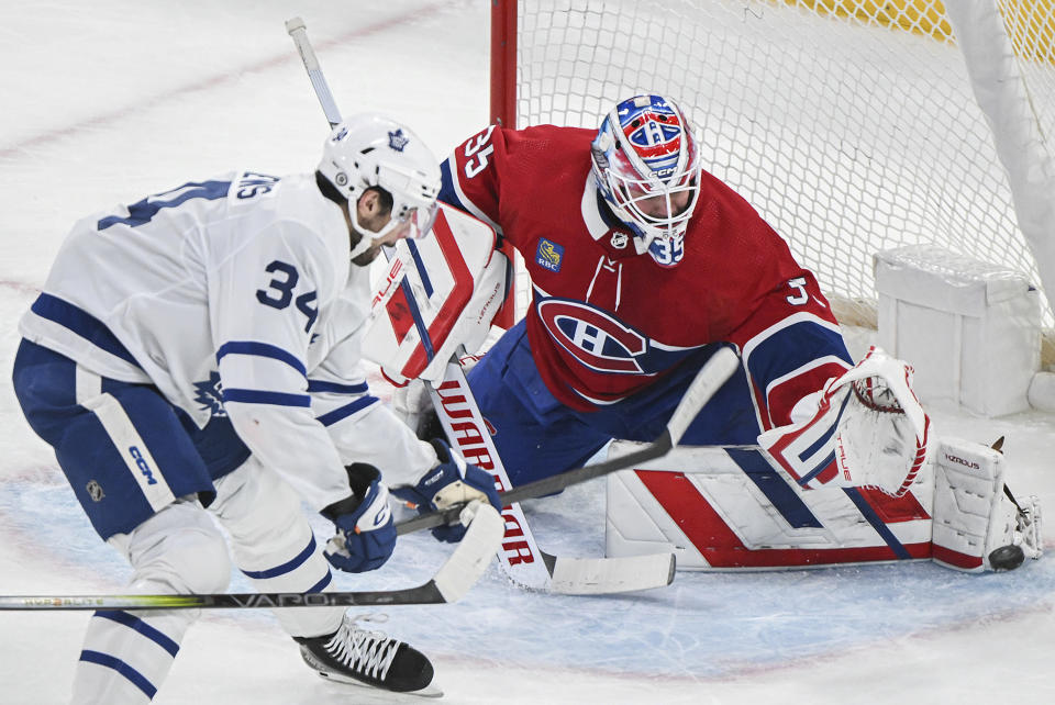 Toronto Maple Leafs' Auston Matthews (34) moves in on Montreal Canadiens goaltender Sam Montembeault during the first period of an NHL hockey game in Montreal, Saturday, April 6, 2024. (Graham Hughes/The Canadian Press via AP)