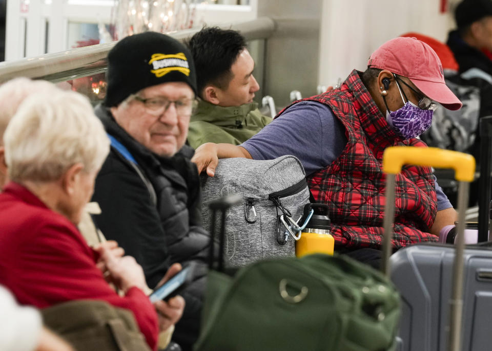 Travelers waits for additional luggage to be unloaded at George Bush Intercontinental Airport, Tuesday, Nov. 21, 2023, in Houston. (Jason Fochtman/Houston Chronicle via AP)